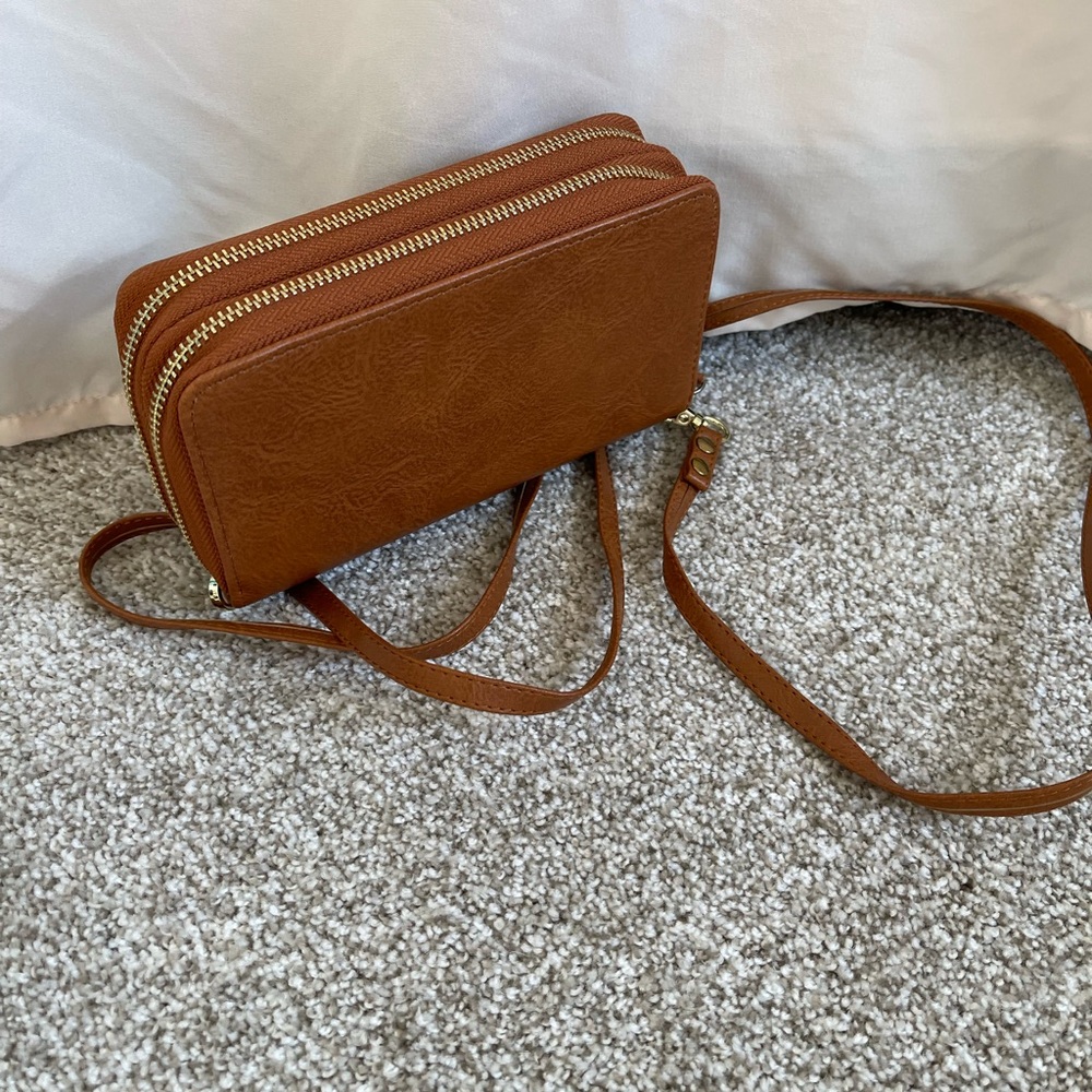 Brown crossbody or wristlet wallet and phone case all in one.